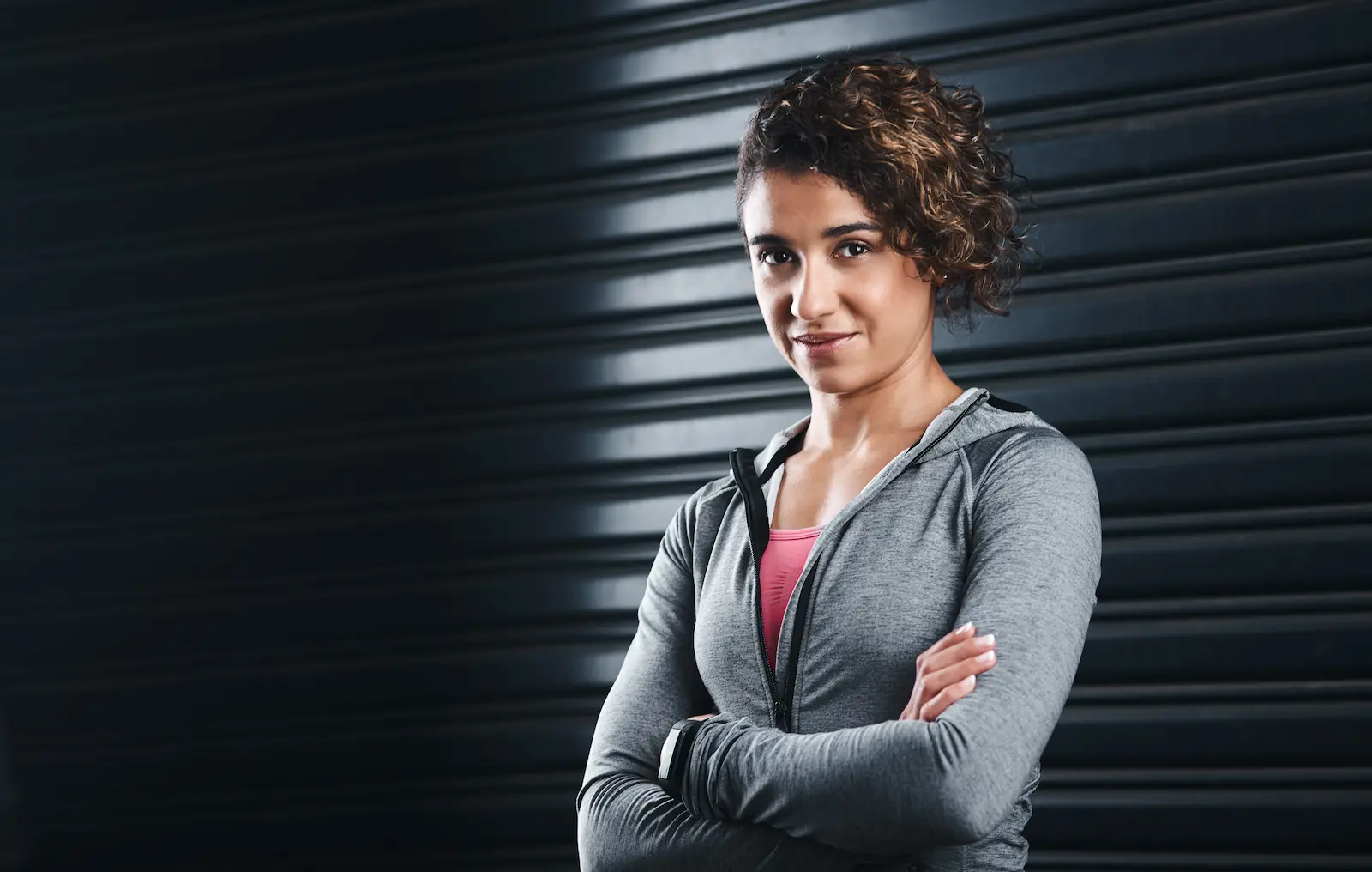 A woman in athletic wear standing confidently