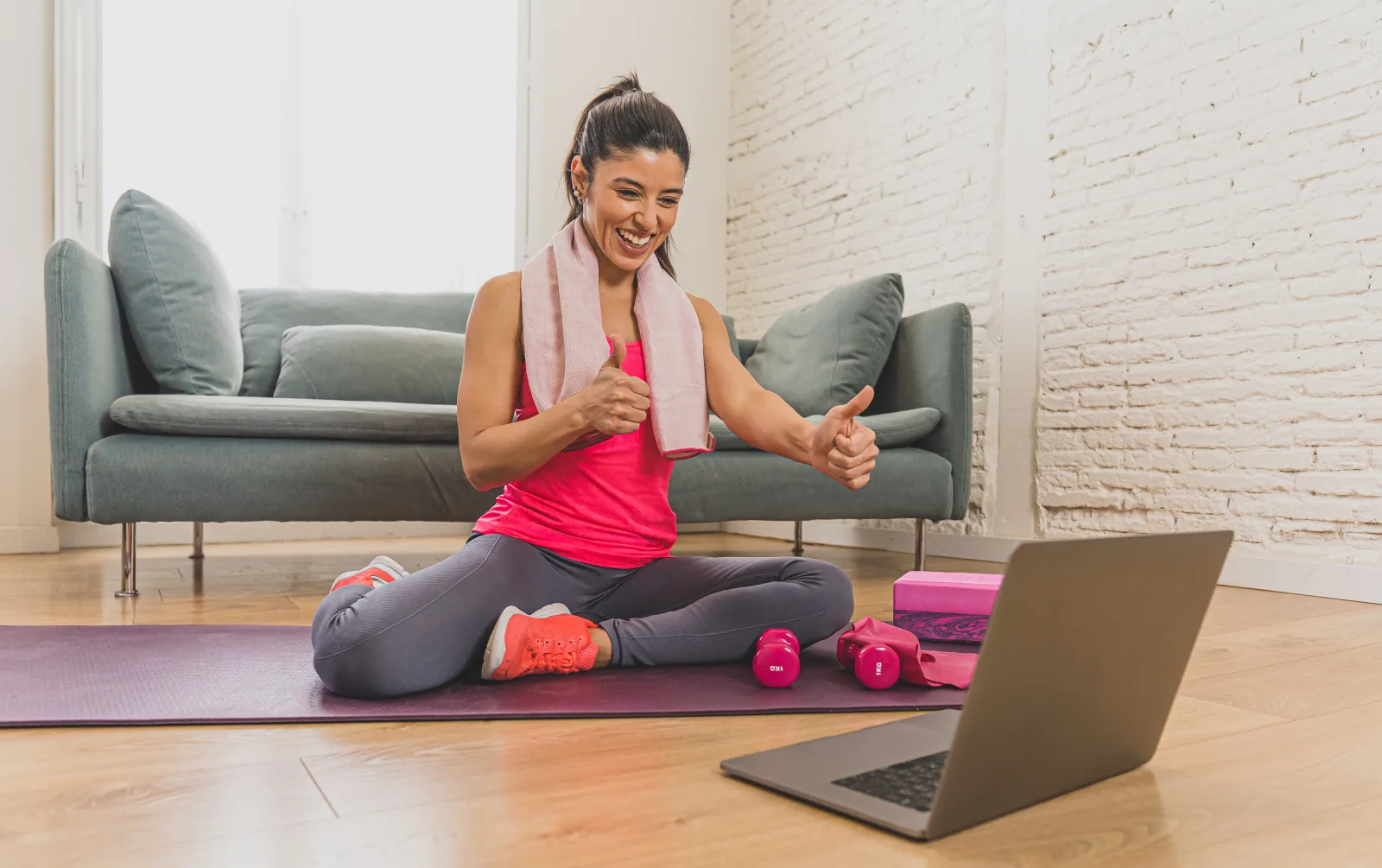 A woman doing a guided strength workout at home
